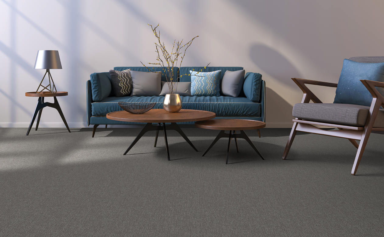 Living room with a blue sofa and dark grey carpet